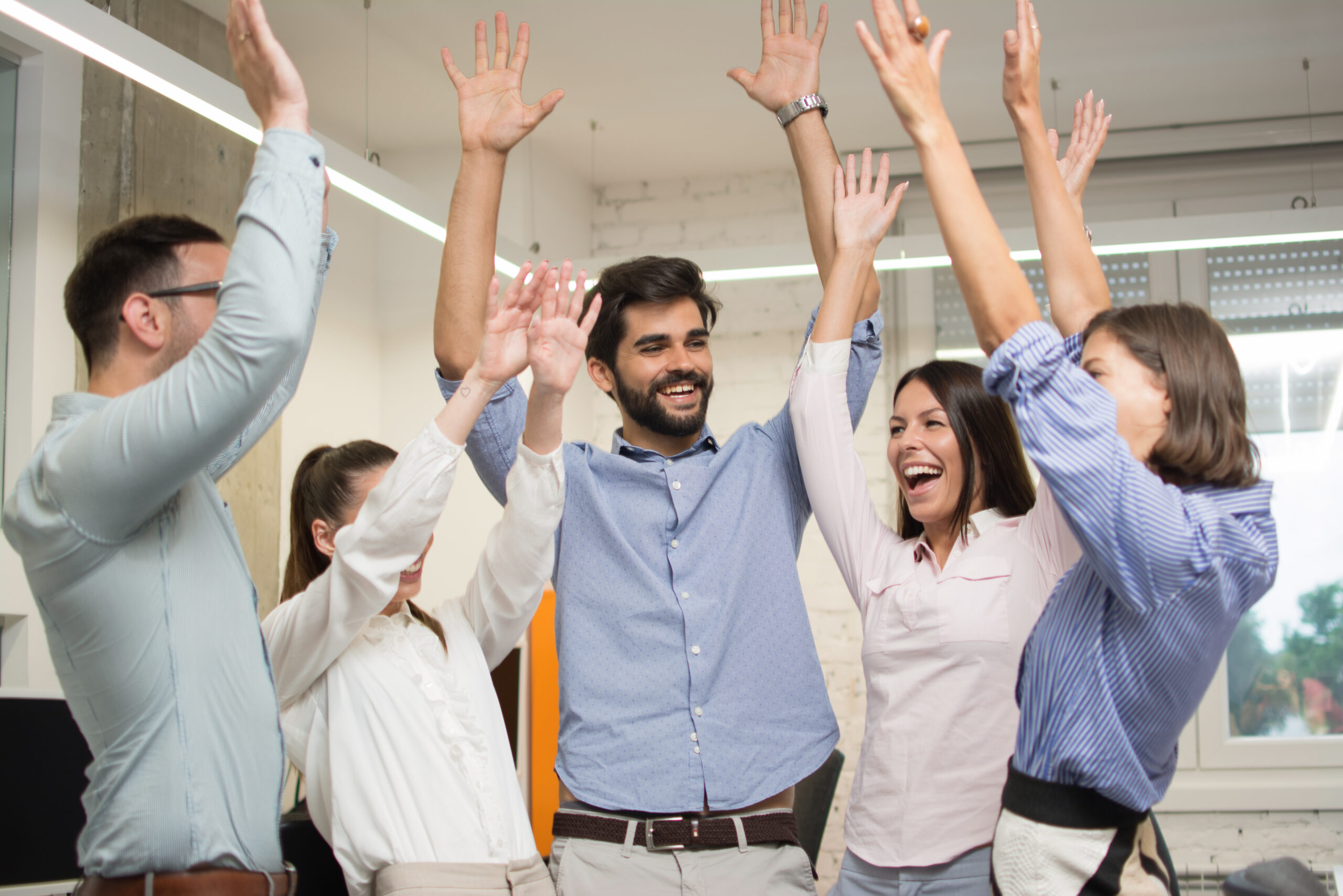 Colleagues celebrating a win together, capturing a moment of shared team success.