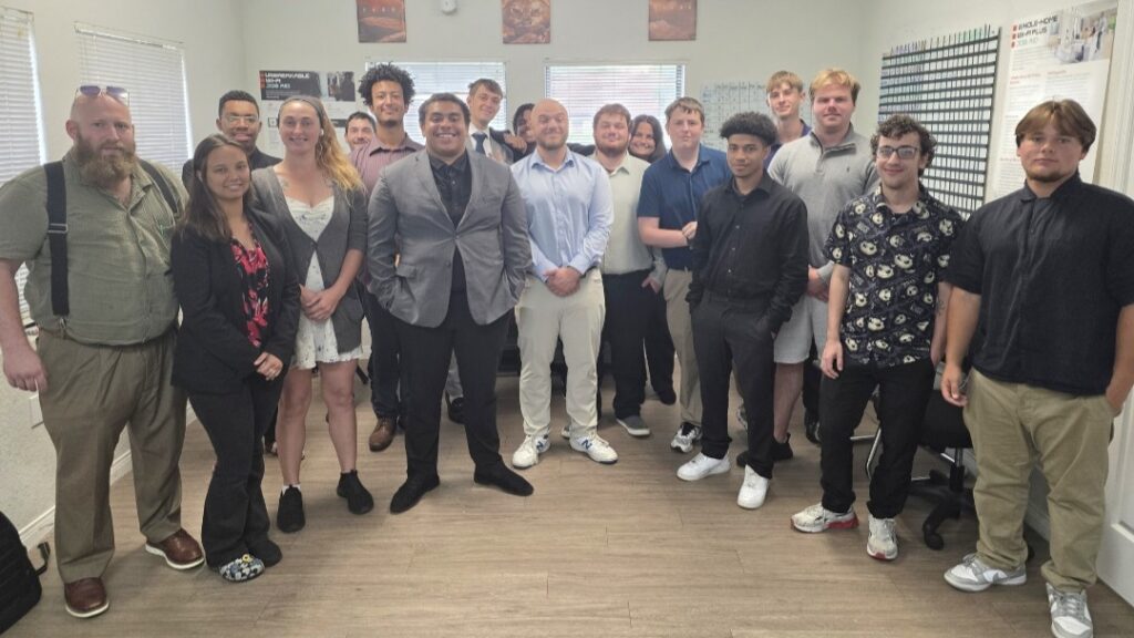 Group photo of employees during a company gathering celebrating teamwork and professional growth.