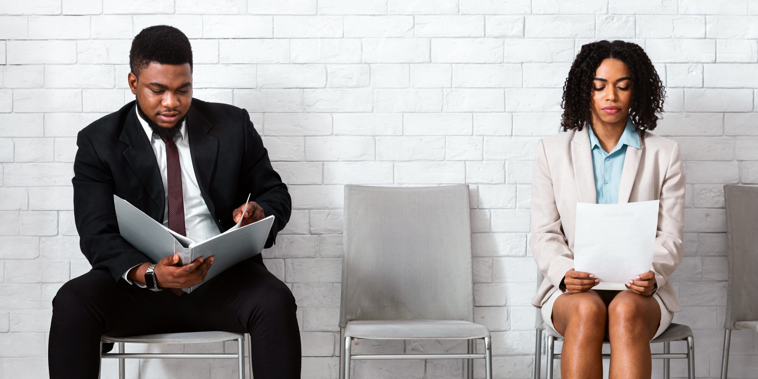 Job seekers reviewing resumes while applying first job interview tips for interview success.